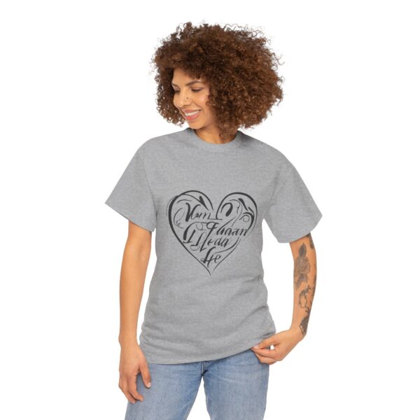 a woman with curly hair wearing a grey t-shirt with a heart on it